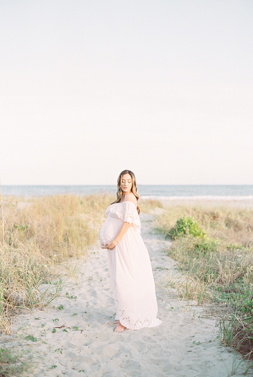 Beach maternity photoshoot on film by Charleston Photographer, Caitlyn Motycka Photography.
