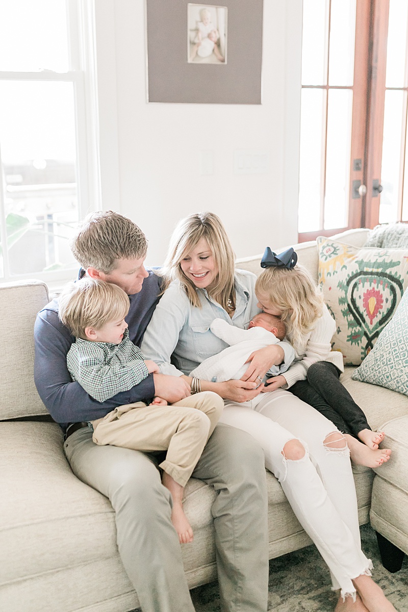 Family snuggles baby during Daniel Island Newborn Session with Caitlyn Motycka Photography.