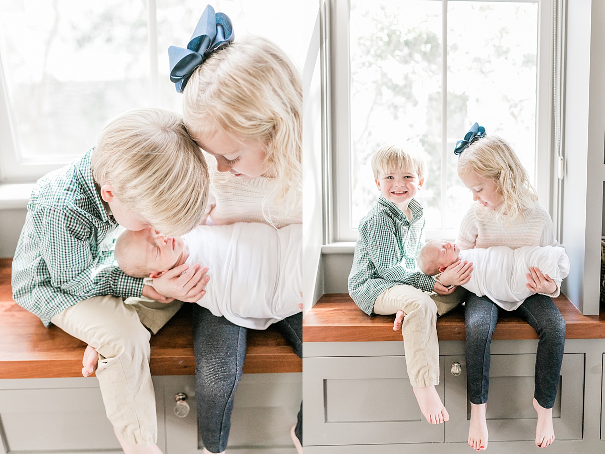Beautiful newborn session in Daniel Island Home. Big brother and sister hold baby brother in window seat. Photos by Caitlyn Motycka Photography.