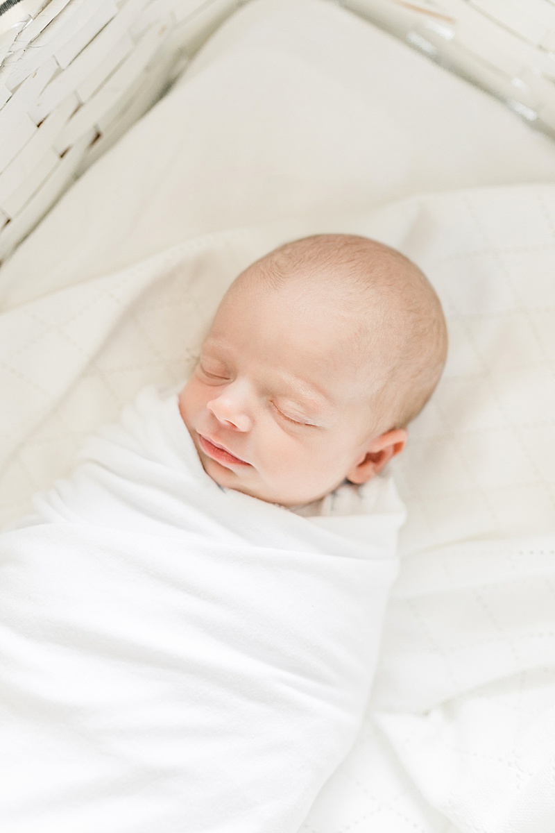 Baby boy swaddled for his lifestyle newborn photoshoot. Photos by Daniel Island Newborn Photographer, Caitlyn Motycka Photography.