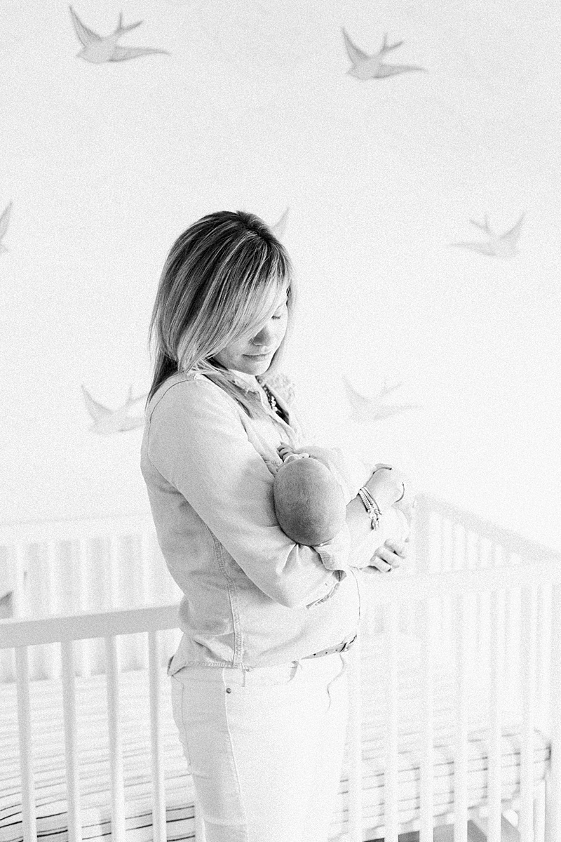 Lifestyle newborn photos in Daniel Island home nursery. Photos by Daniel Island Newborn Photographer, Caitlyn Motycka Photography.