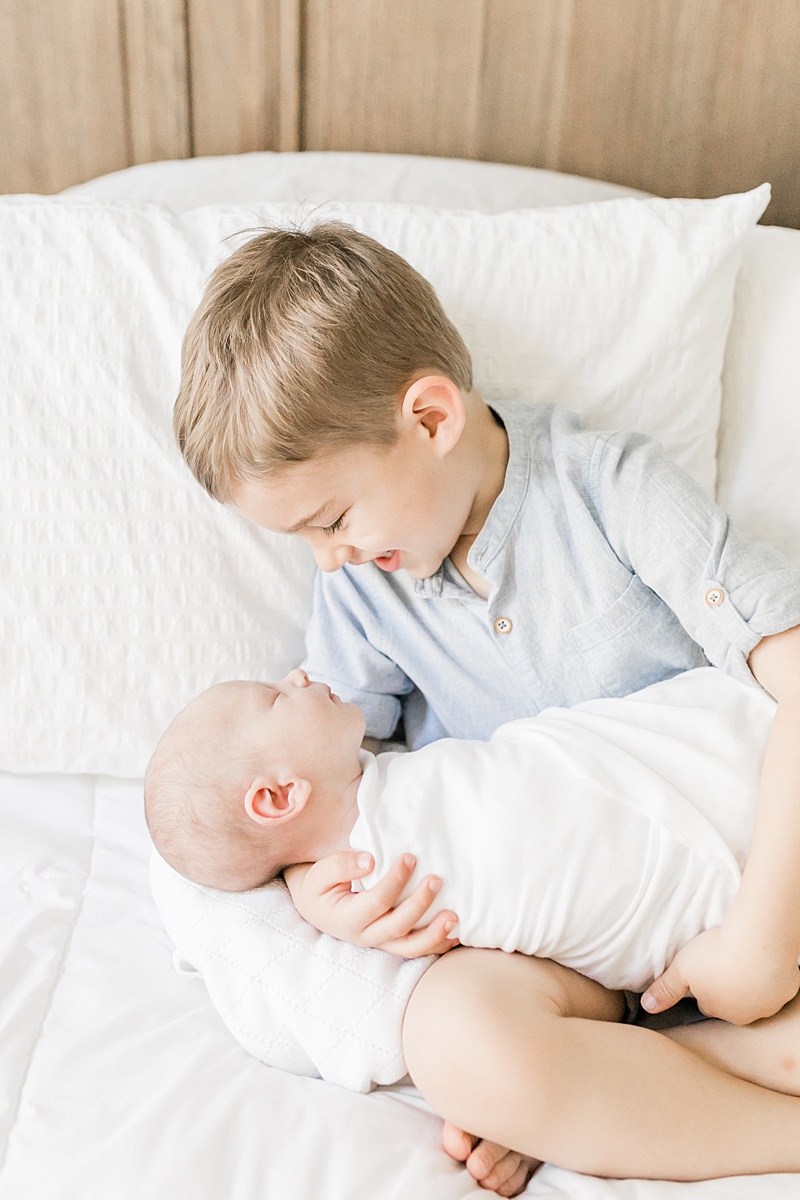 Big brother and baby brother together during lifestyle newborn session in Mount Pleasant, SC. Photos by Caitlyn Motycka Photography. 