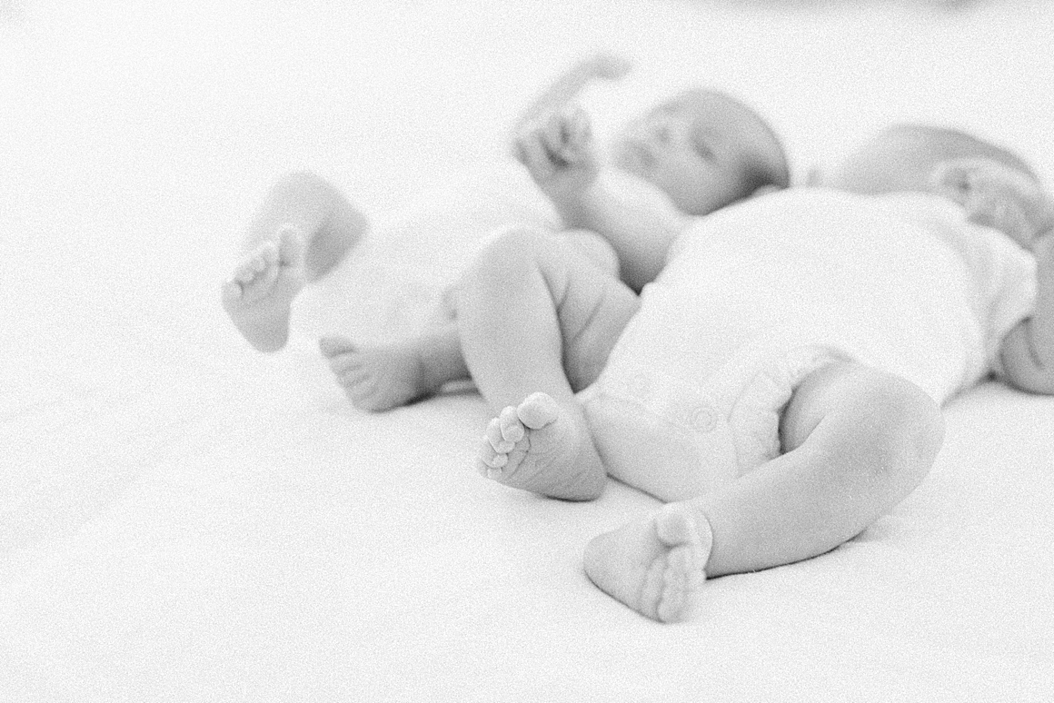 Black and white photo of twin boys during in-home newborn session. Photos by Caitlyn Motycka Photography.