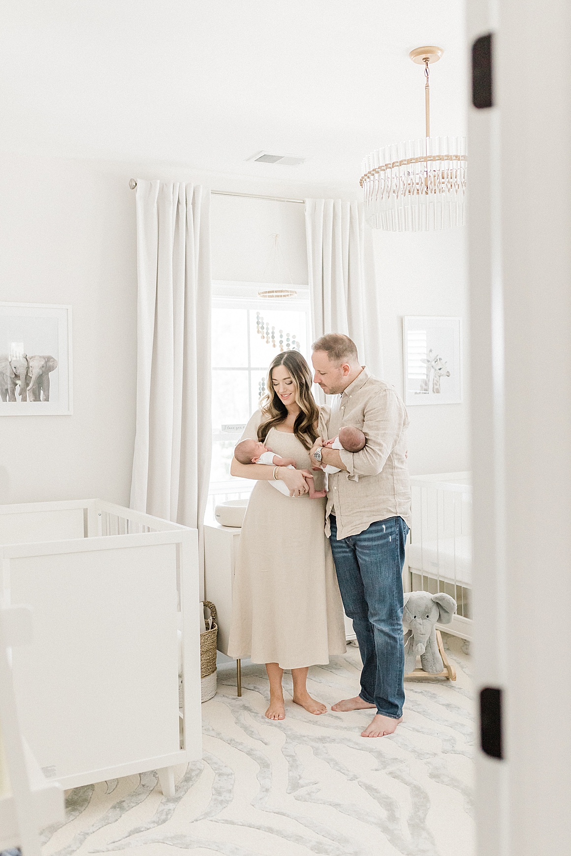 Lifestyle newborn session with twins in a beautiful, neutral nursery. Photos by Charleston Baby Photographer, Caitlyn Motycka Photography.