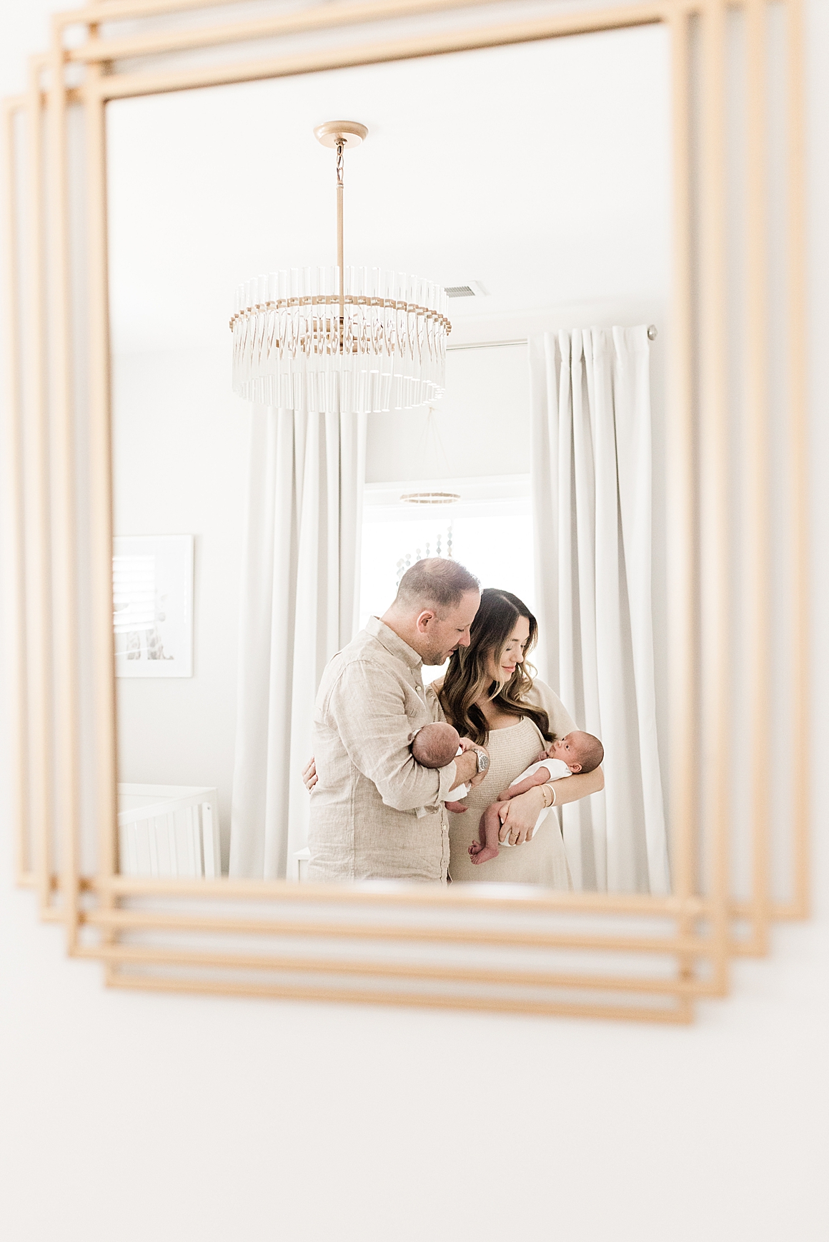 Lifestyle newborn session with twins in a beautiful, neutral nursery. Photos by Charleston Baby Photographer, Caitlyn Motycka Photography.