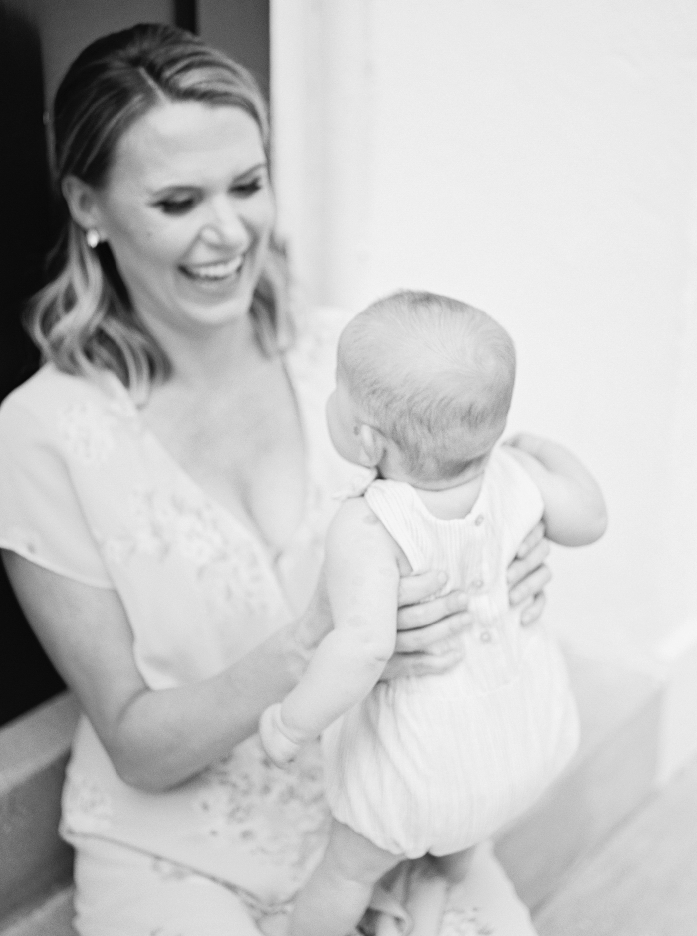 Black and white image of mom with baby. Photo by Caitlyn Motycka Photography.