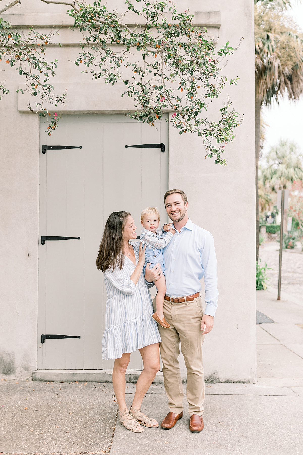 Family of 3 strolling the streets of Downtown Charleston for photos with Caitlyn Motycka Photography.