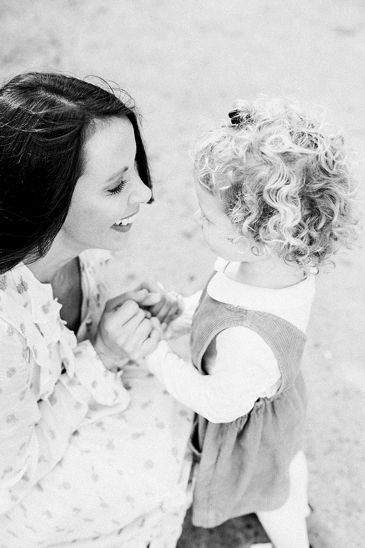 Black and white photo of Mom and daughter at family photoshoot in Charleston, SC. Photos by Caitlyn Motycka Photography.