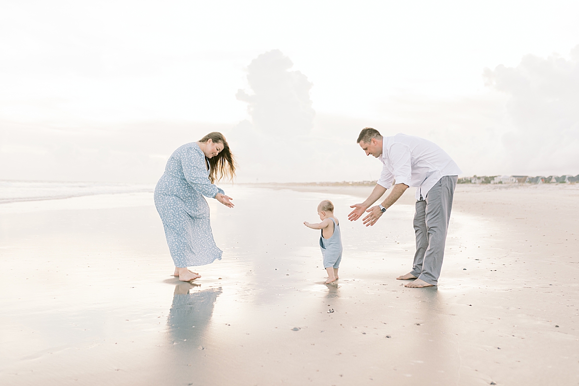 One year old walking on the beach during milestone photoshoot with Caitlyn Motycka Photography.