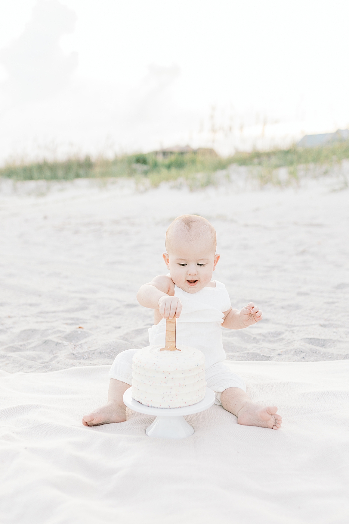 First birthday milestone session and cake smash at the beach. Photos by Isle of Palms Photographer, Caitlyn Motycka Photography.