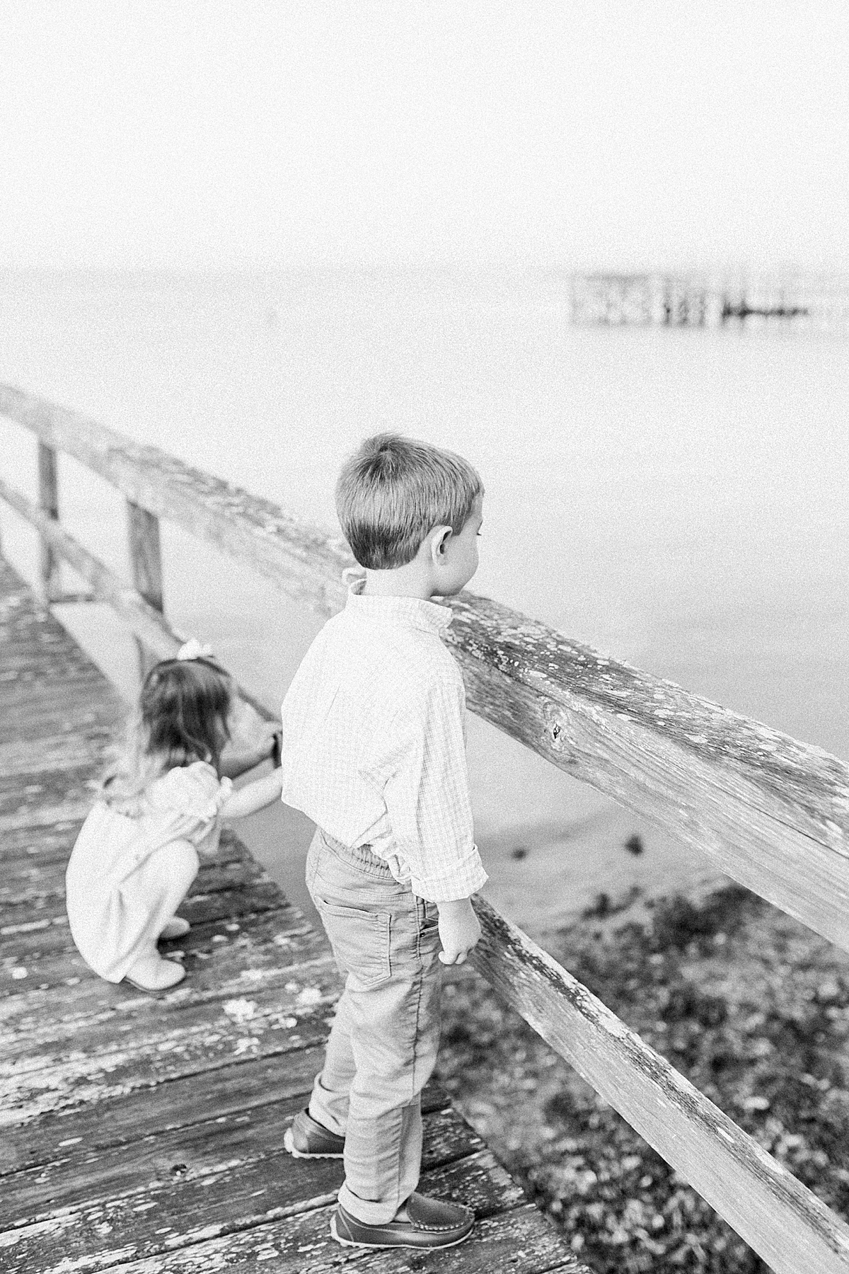 Kids overlooking the water on family dock in Mount Pleasant. Photos by Caitlyn Motycka Photography.