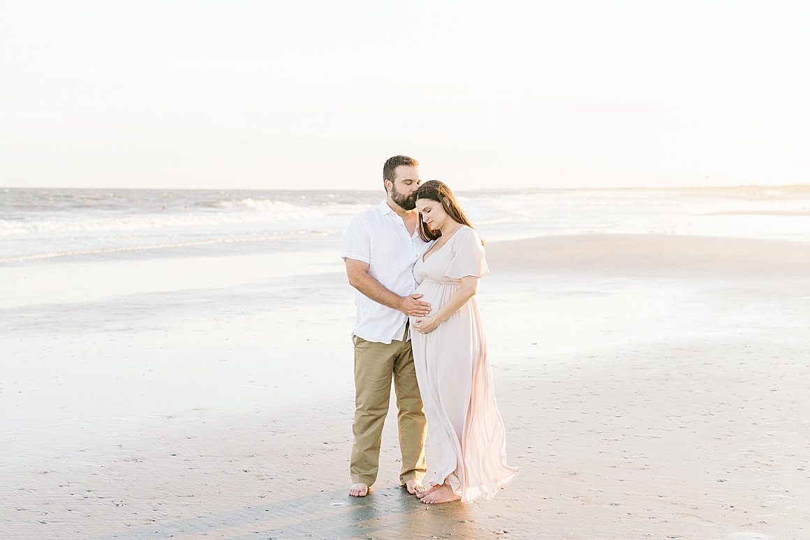 Sunset maternity session by the water in Charleston, SC. Photos by Caitlyn Motycka Photography.