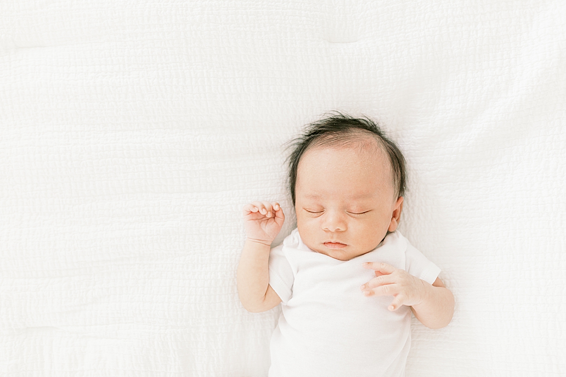 Baby boy laying on bed during in-home lifestyle newborn session. Photos by Charleston Photographer, Caitlyn Motycka Photography.