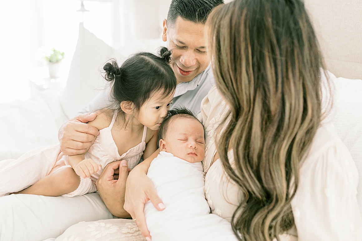 In-home lifestyle newborn photoshoot in master bedroom. Photos by Caitlyn Motycka Photography.