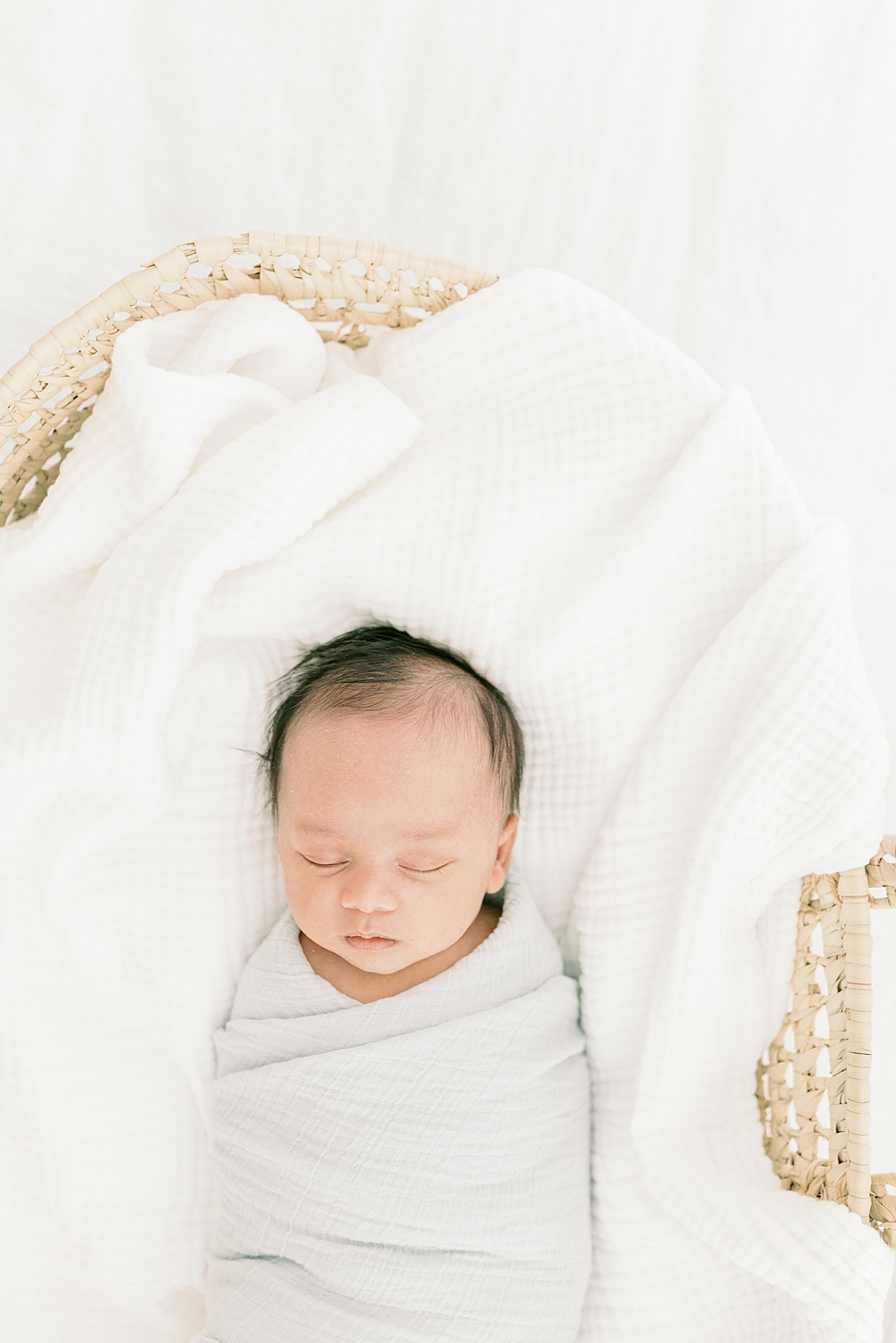 Baby swaddled in Moses Basket for in-home newborn session. Photos by Charleston Newborn Photographer, Caitlyn Motycka Photography.