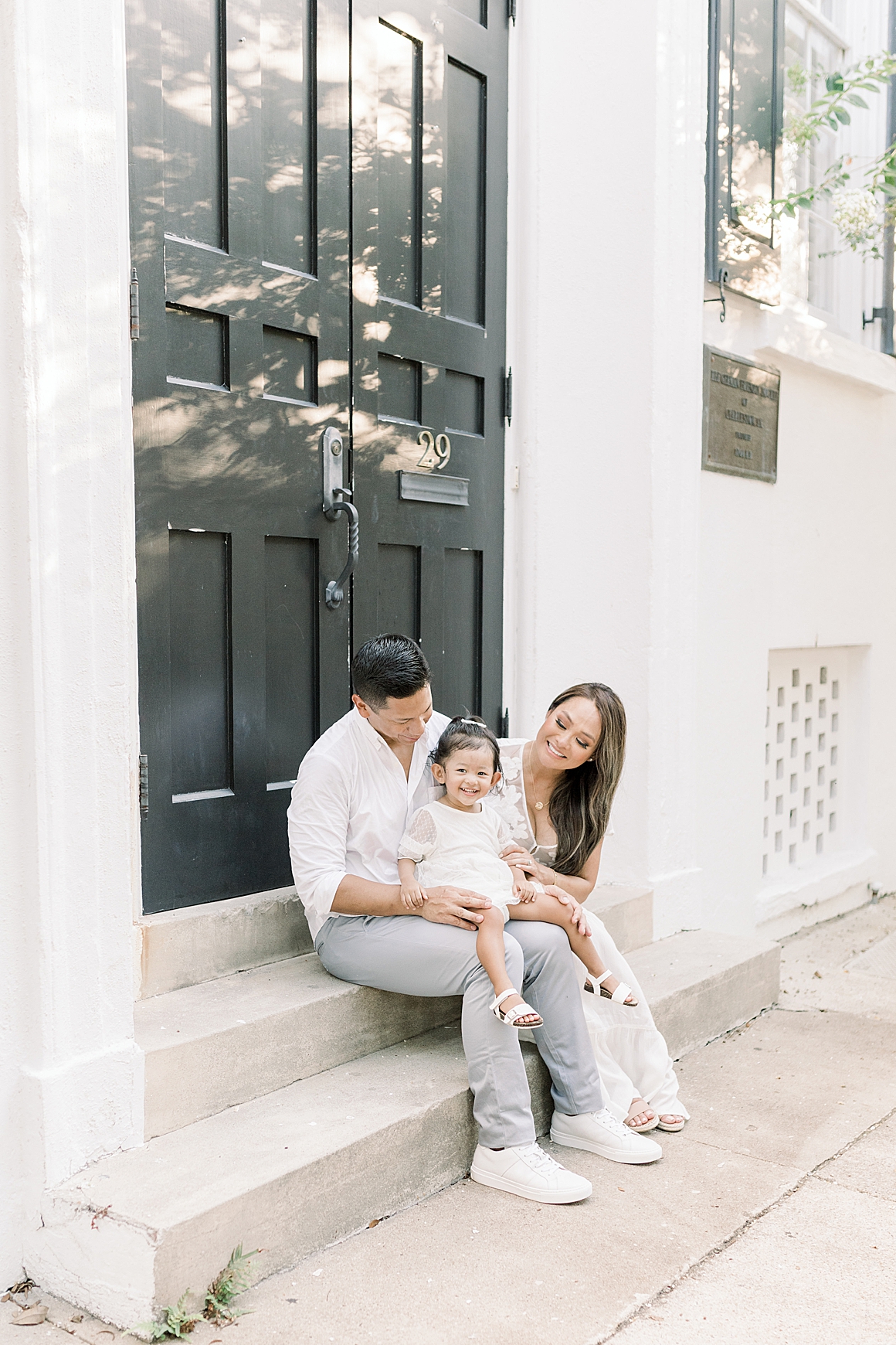 Family sitting on doorsteps of front porch in Charleston. Photos by Caitlyn Motycka Photography.