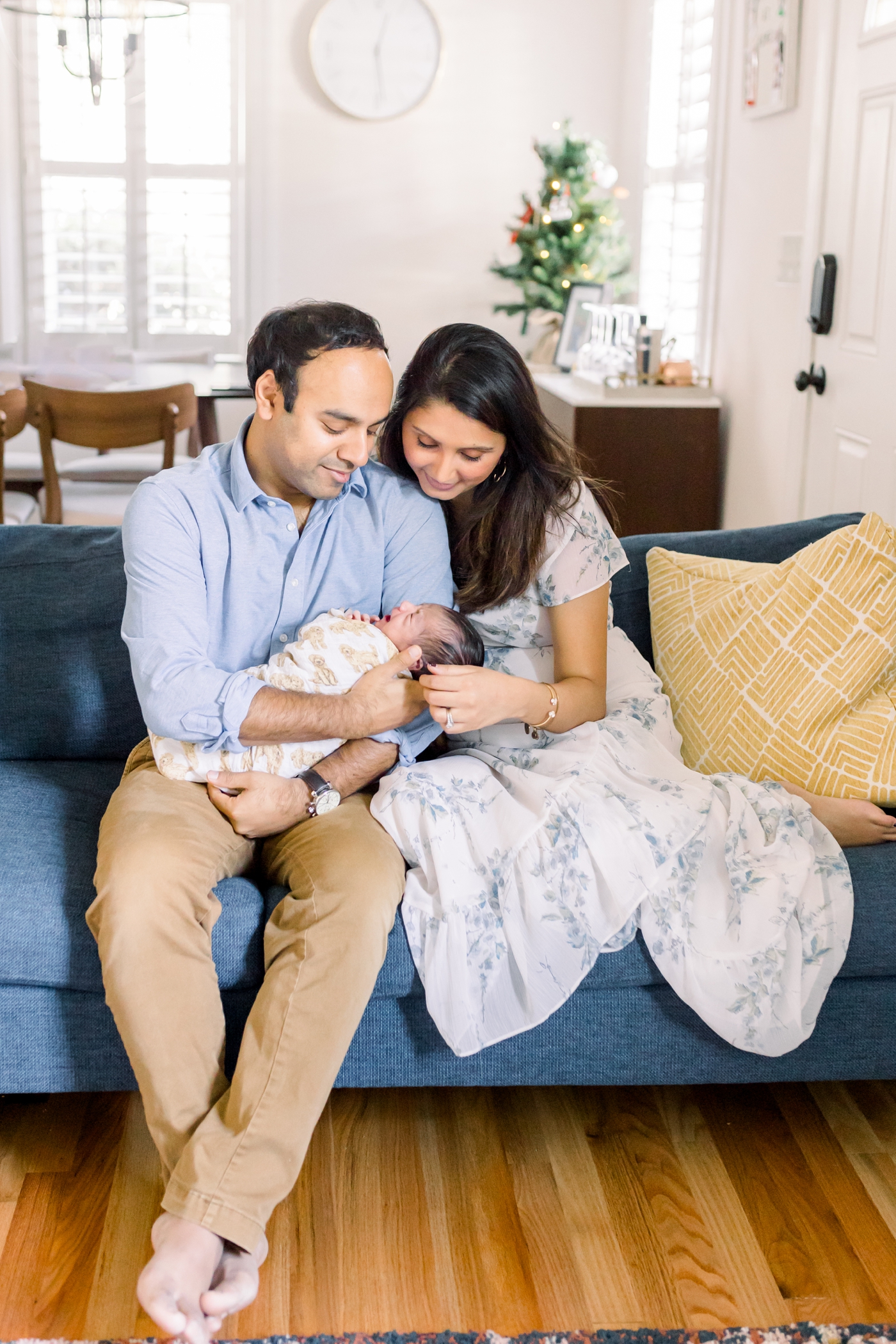 Family photo sitting on the couch during in-home newborn session with Charleston Photographer, Caitlyn Motycka Photography.