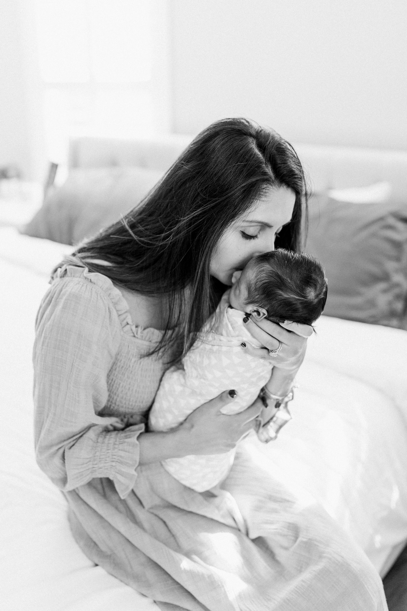 Mama kissing her baby boy. Photo by Charleston Newborn Photographer, Caitlyn Motycka Photography.
