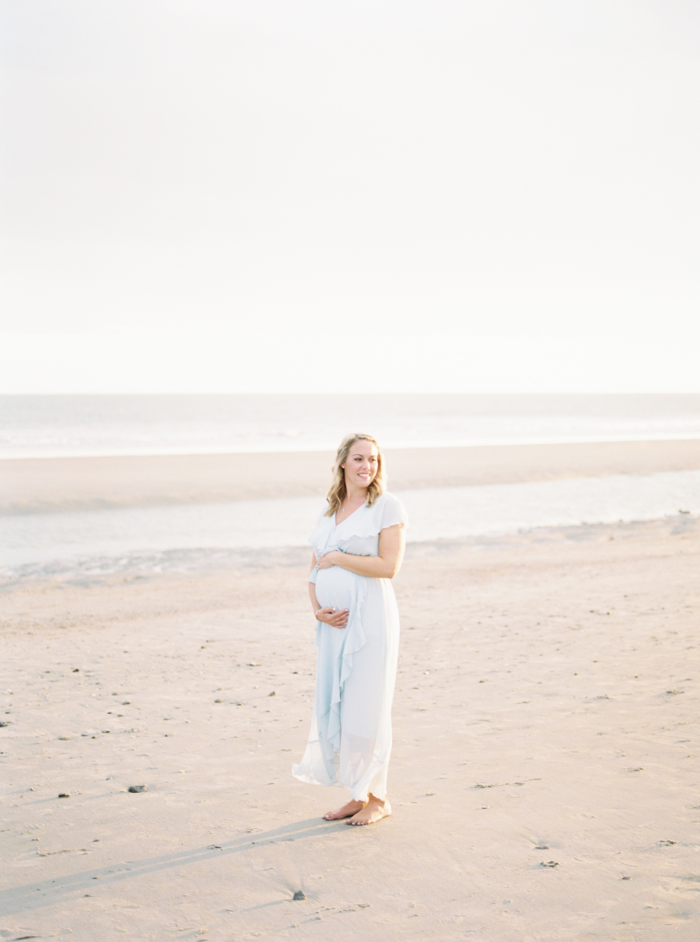 Maternity photo on film at the beach. Photo by Caitlyn Motycka Photography.