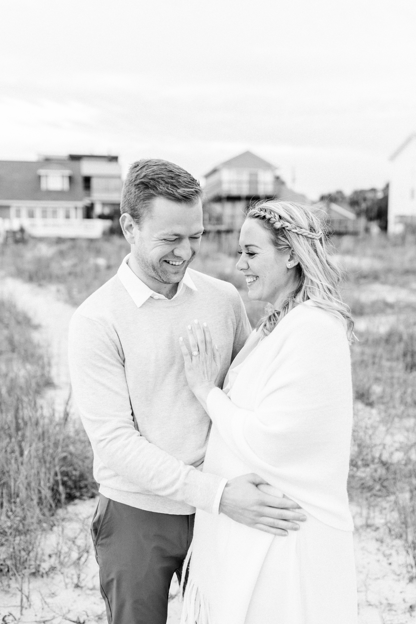 Mom and Dad-to-be laughing during maternity photoshoot in Charleston Caitlyn Motycka Photography.