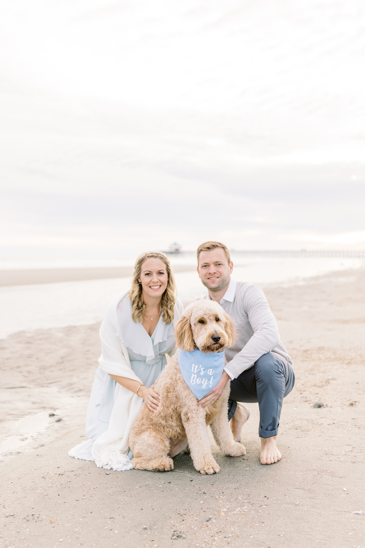 Gender reveal with dog on the beach. Photo by Caitlyn Motycka Photography.