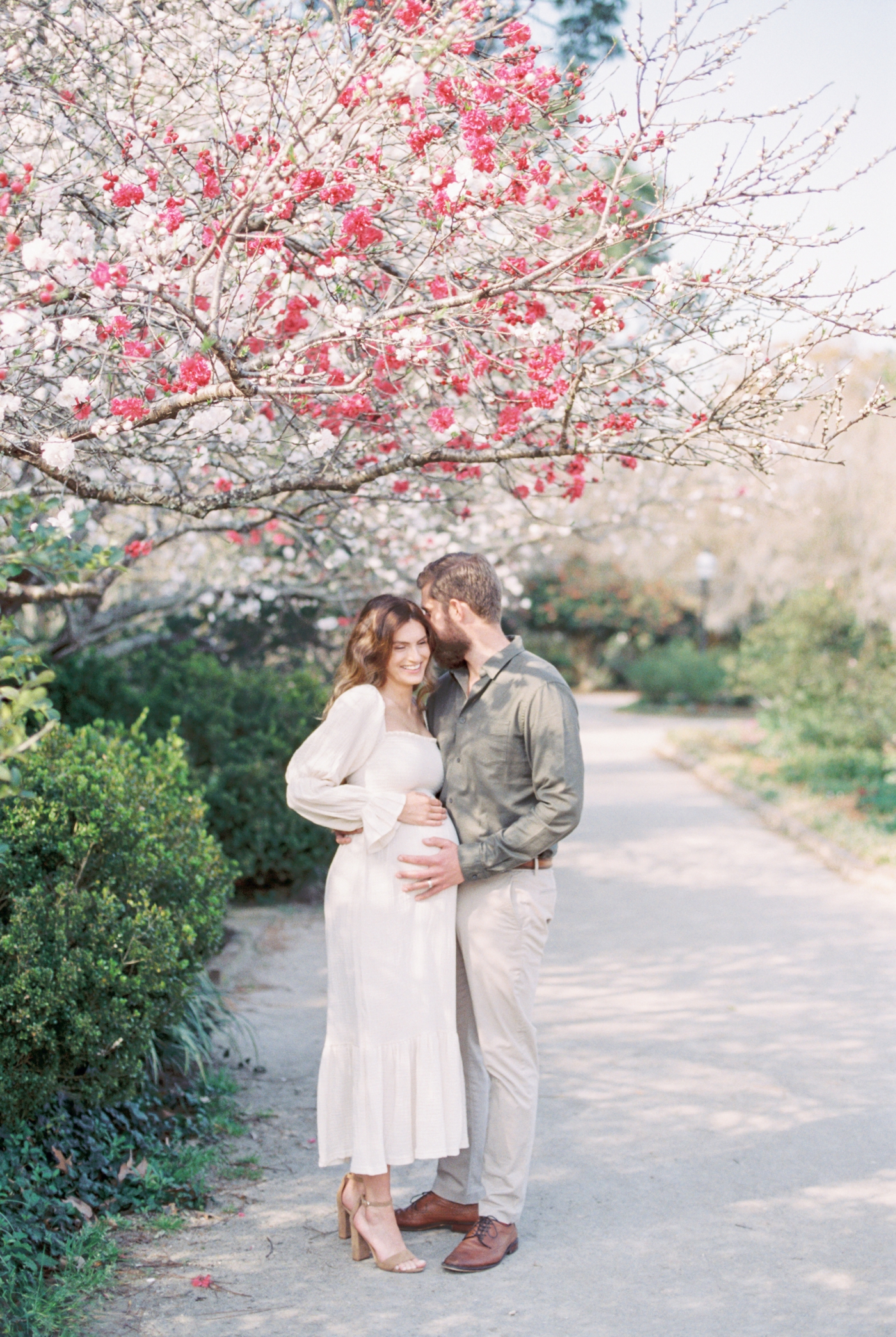 Sweet moment with Mom and Dad during film maternity session in Charleston by Caitlyn Motycka Photography.