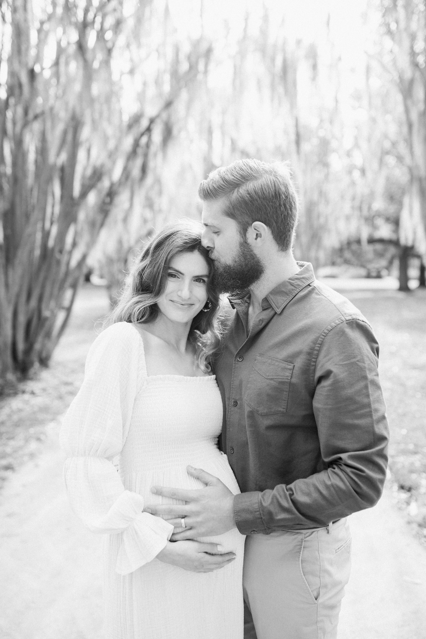 Black and white portrait of husband and wife during maternity session with Charleston photographer, Caitlyn Motycka Photography.