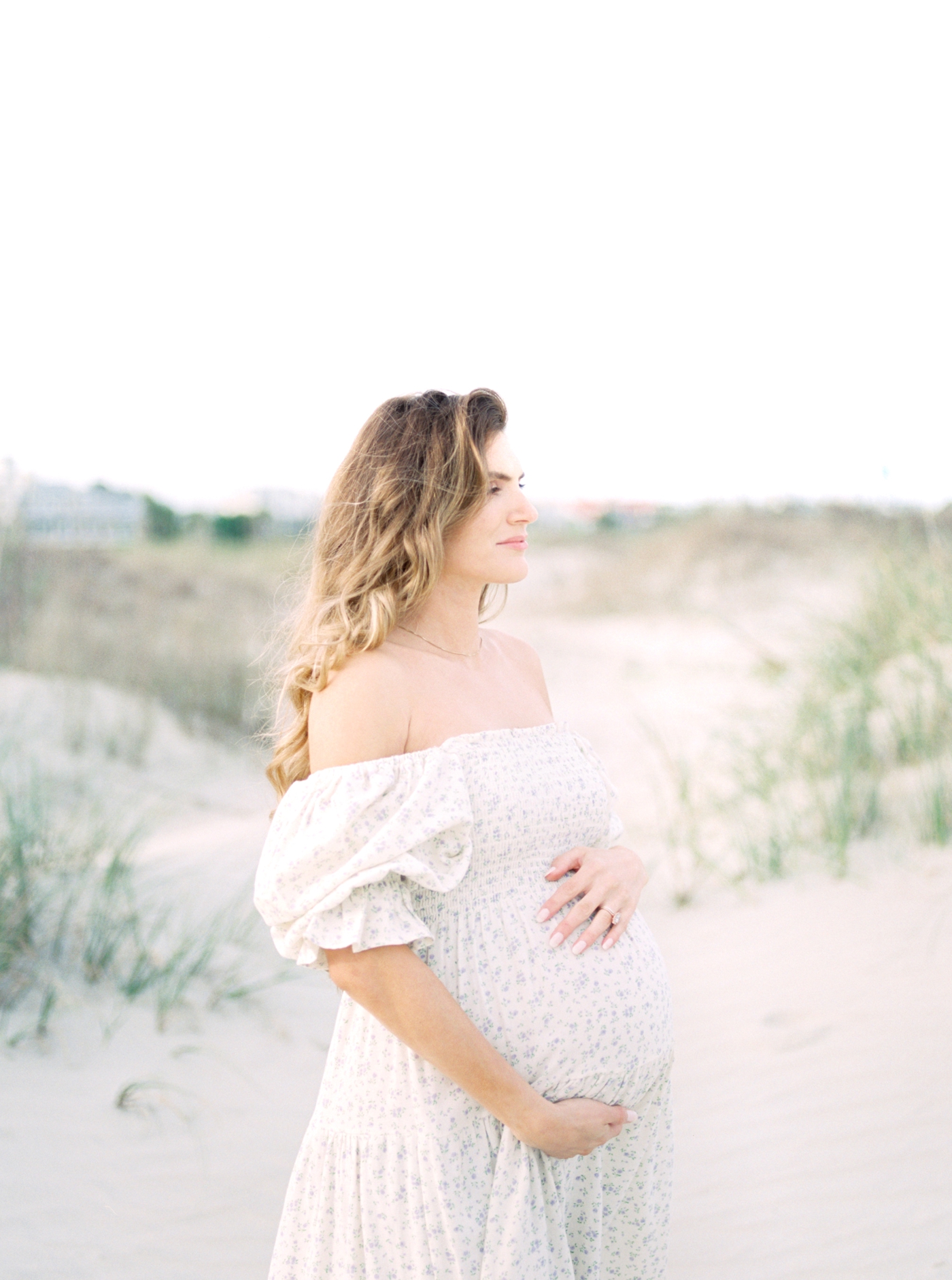 Pregnant woman on the beach | Photo by Caitlyn Motycka Photography.