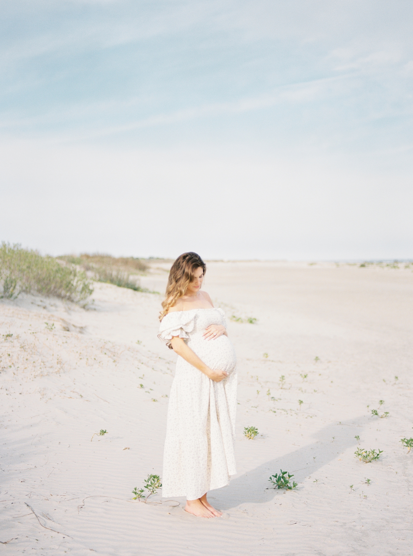 Film Photo of Pregnant woman on the beach | Photo by Caitlyn Motycka Photography.