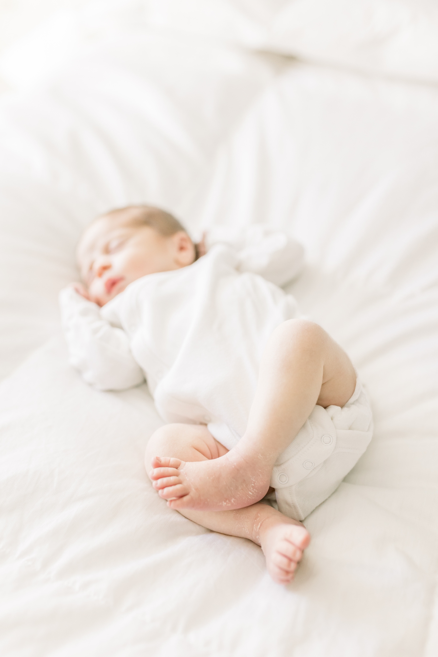 Detail of sleeping newborn baby's legs | Photo by Caitlyn Motycka Photography.