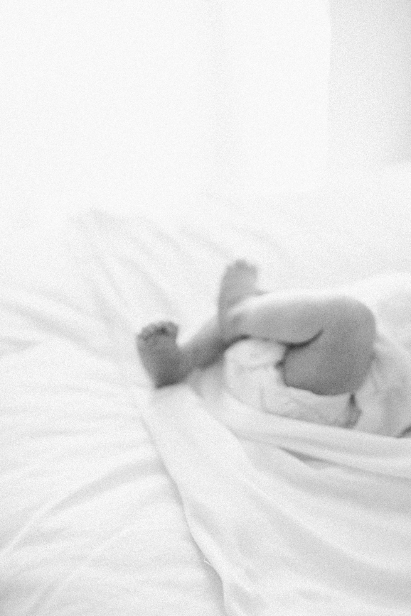 Black and white photo of newborn baby feet | Photo by Caitlyn Motycka Photography.