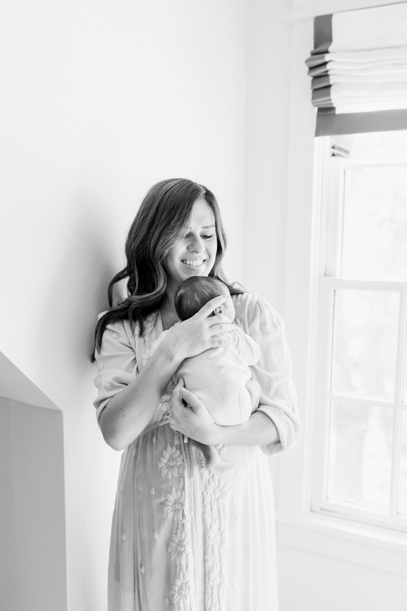 Black and white photo of mom holding her new baby | Photo by Caitlyn Motycka Photography.