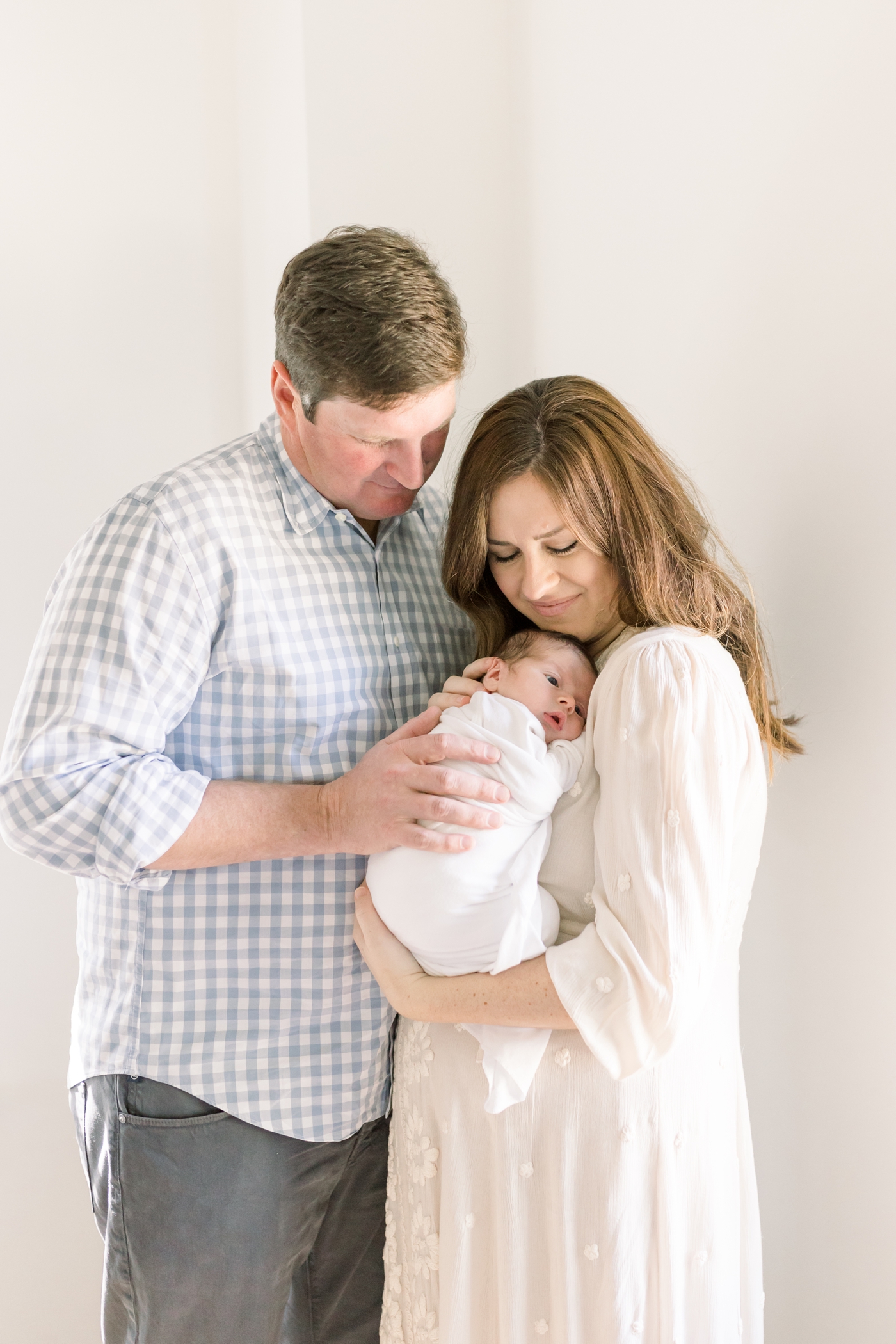 Mom and dad holding their new baby | Photo by Caitlyn Motycka Photography.