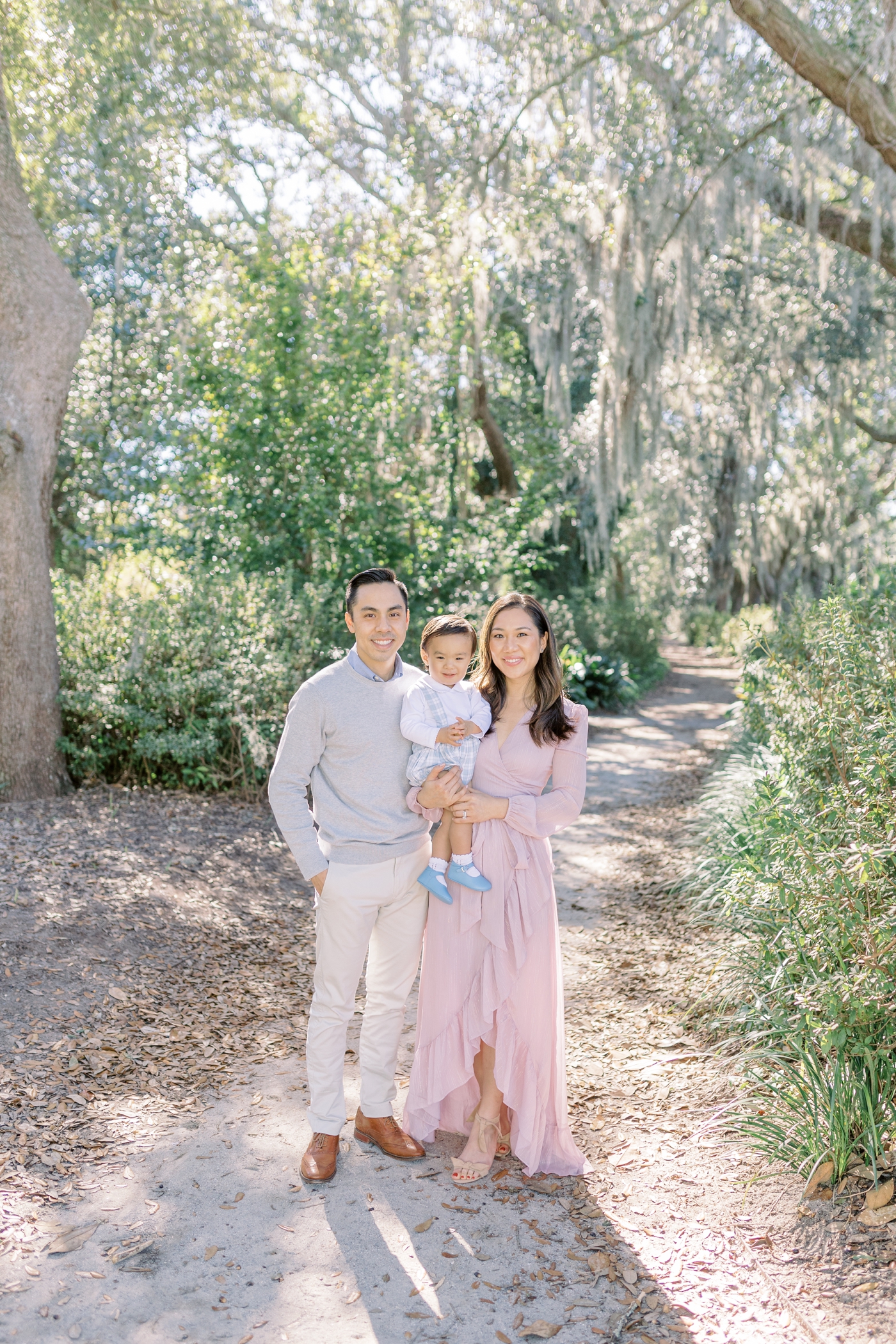 Family smiling at the camera during Hampton Park mini session | Photo by Caitlyn Motycka Photography