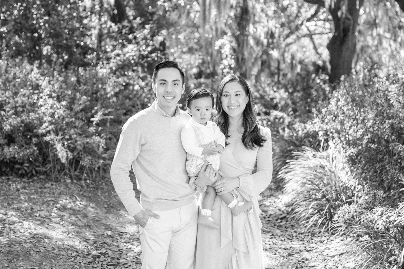 Black and white photo of family of three in Hampton Park during mini session | Photo by Caitlyn Motycka Photography