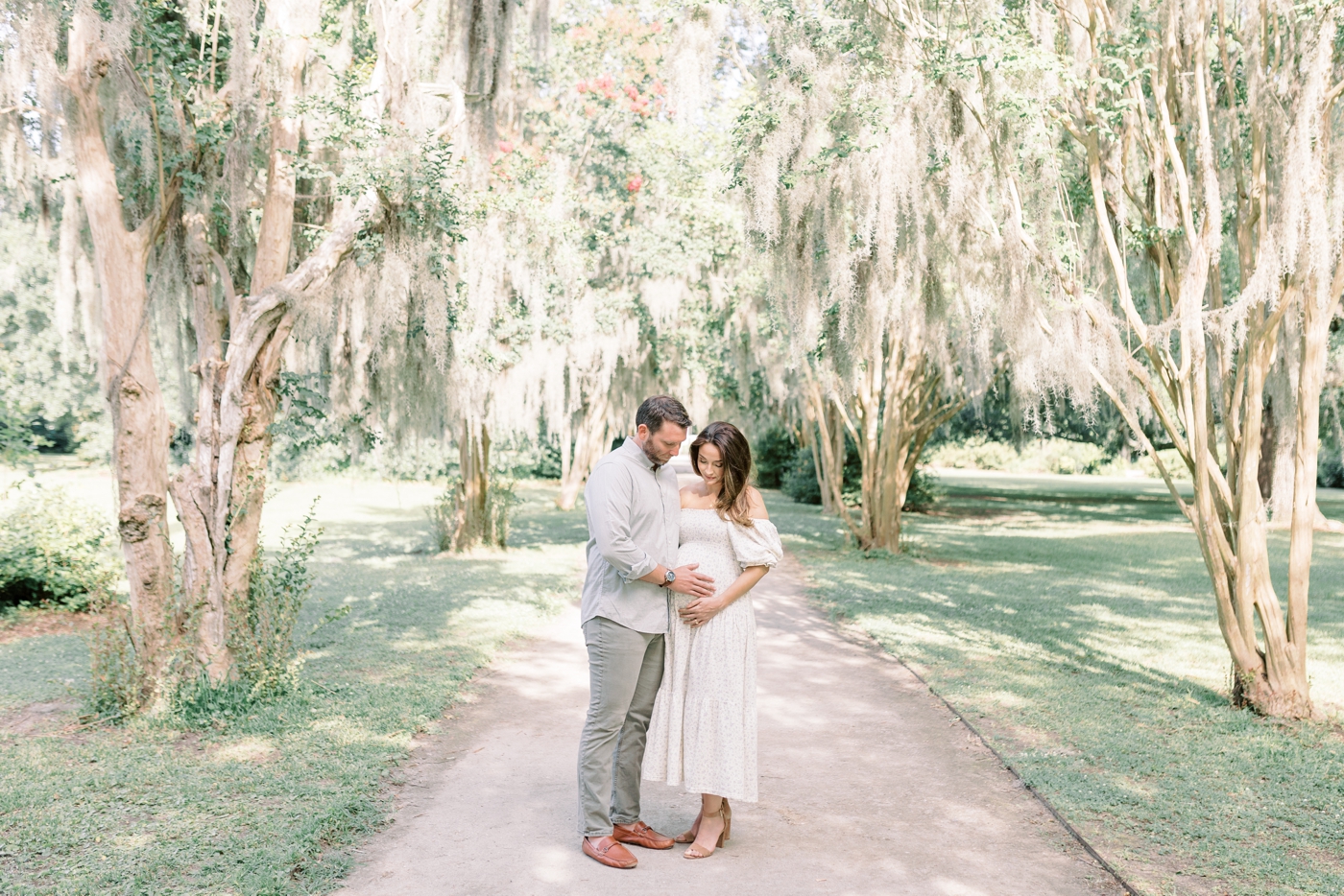 Mom and dad to be under crepe myrtle trees | Photo by Caitlyn Motycka Photography.