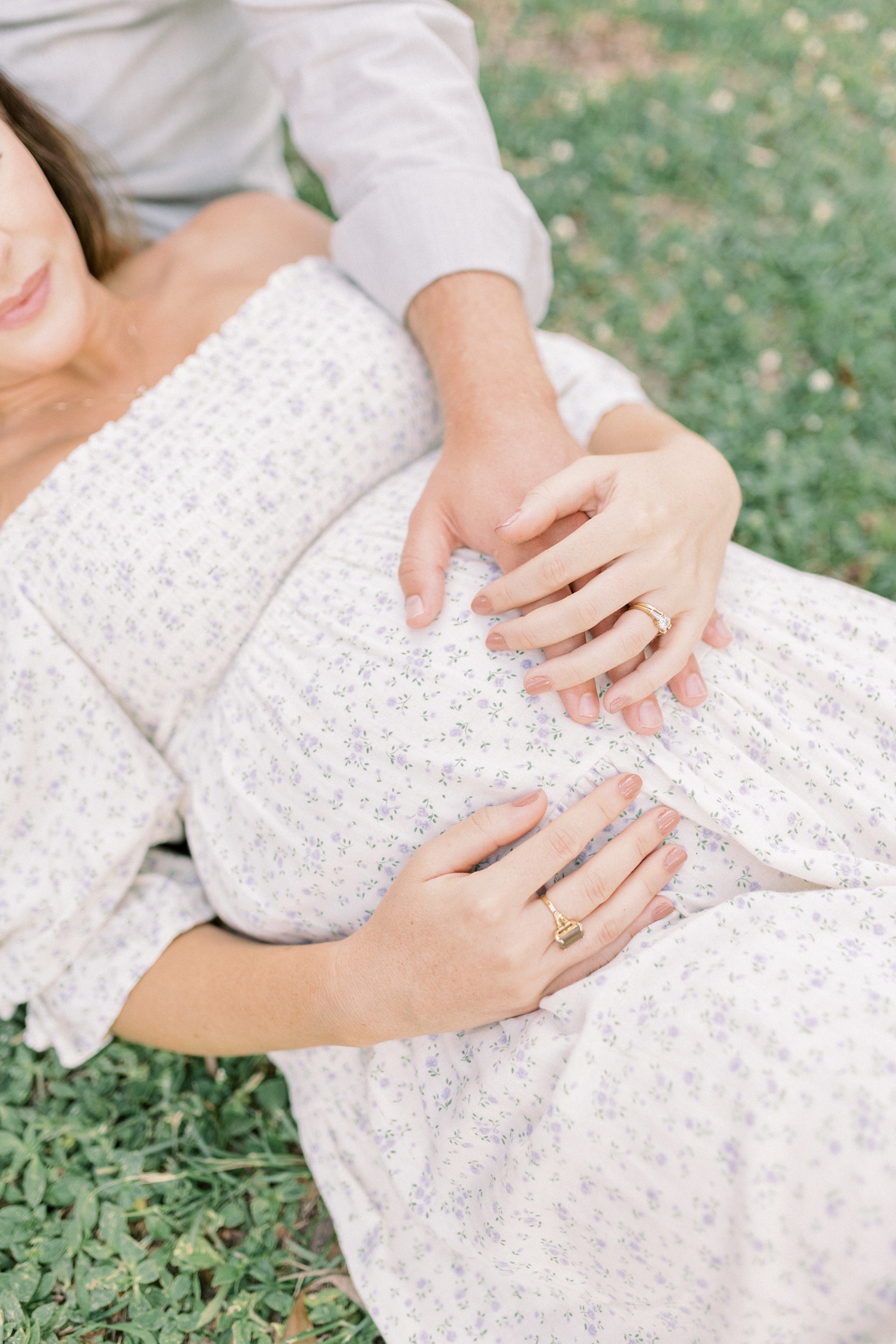 Detail of hands on mom's belly | Photo by Caitlyn Motycka Photography.