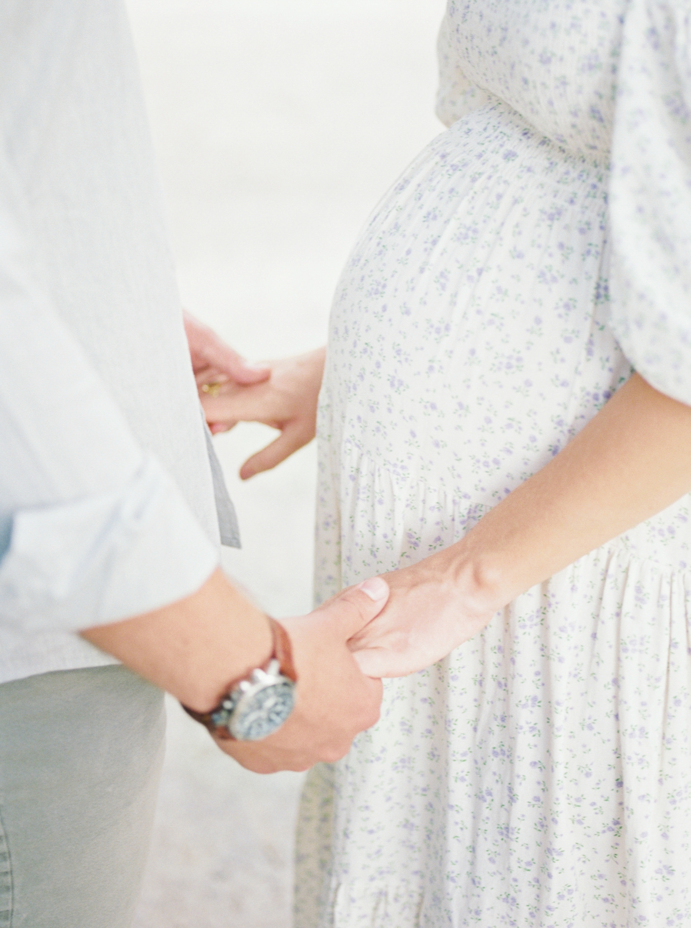 Detail of hands with expectant mom's belly | Photo by Caitlyn Motycka Photography.
