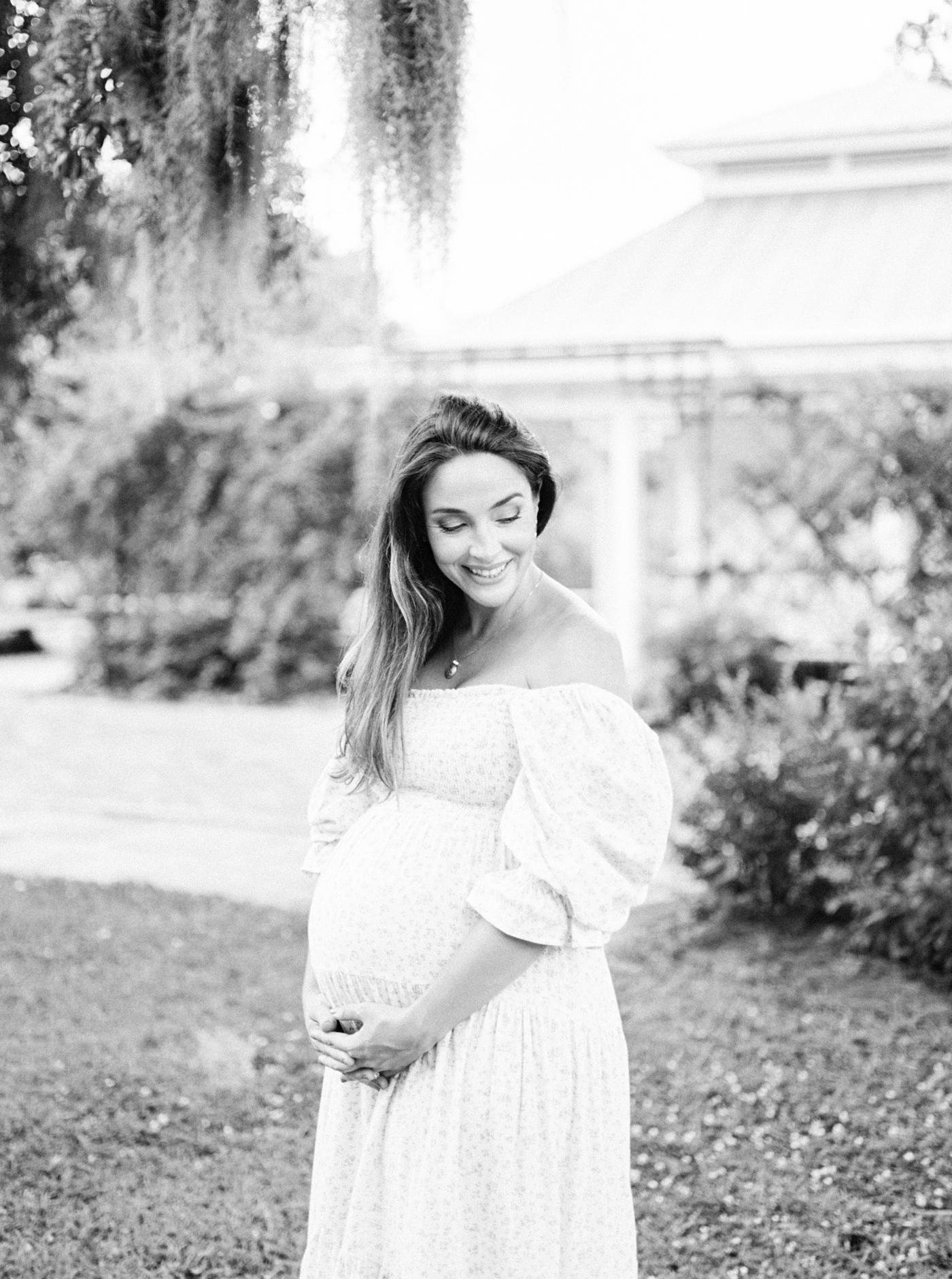 Black and white photo of expecting mom in Hampton Park | Photo by Caitlyn Motycka Photography.
