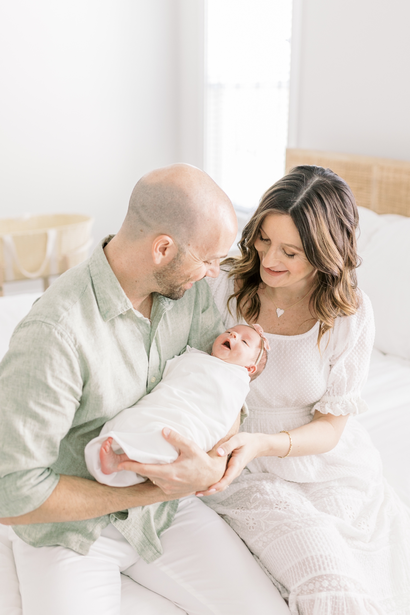 Dad and mom holding their new baby during their lifestyle newborn session | Photo by Caitlyn Motycka Photography