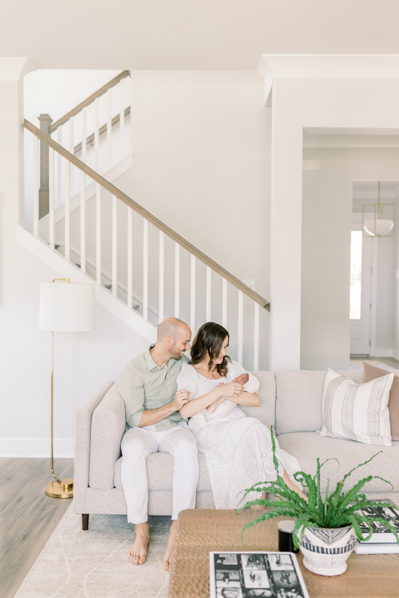 Mom and dad interacting with their new baby during their lifestyle newborn session | Photo by Caitlyn Motycka Photography