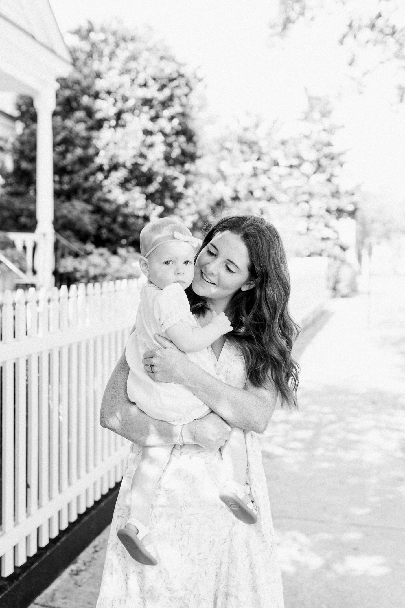 Black and white film image of mom and baby daughter downtown Charleston | Photo by Caitlyn Motycka Photography.