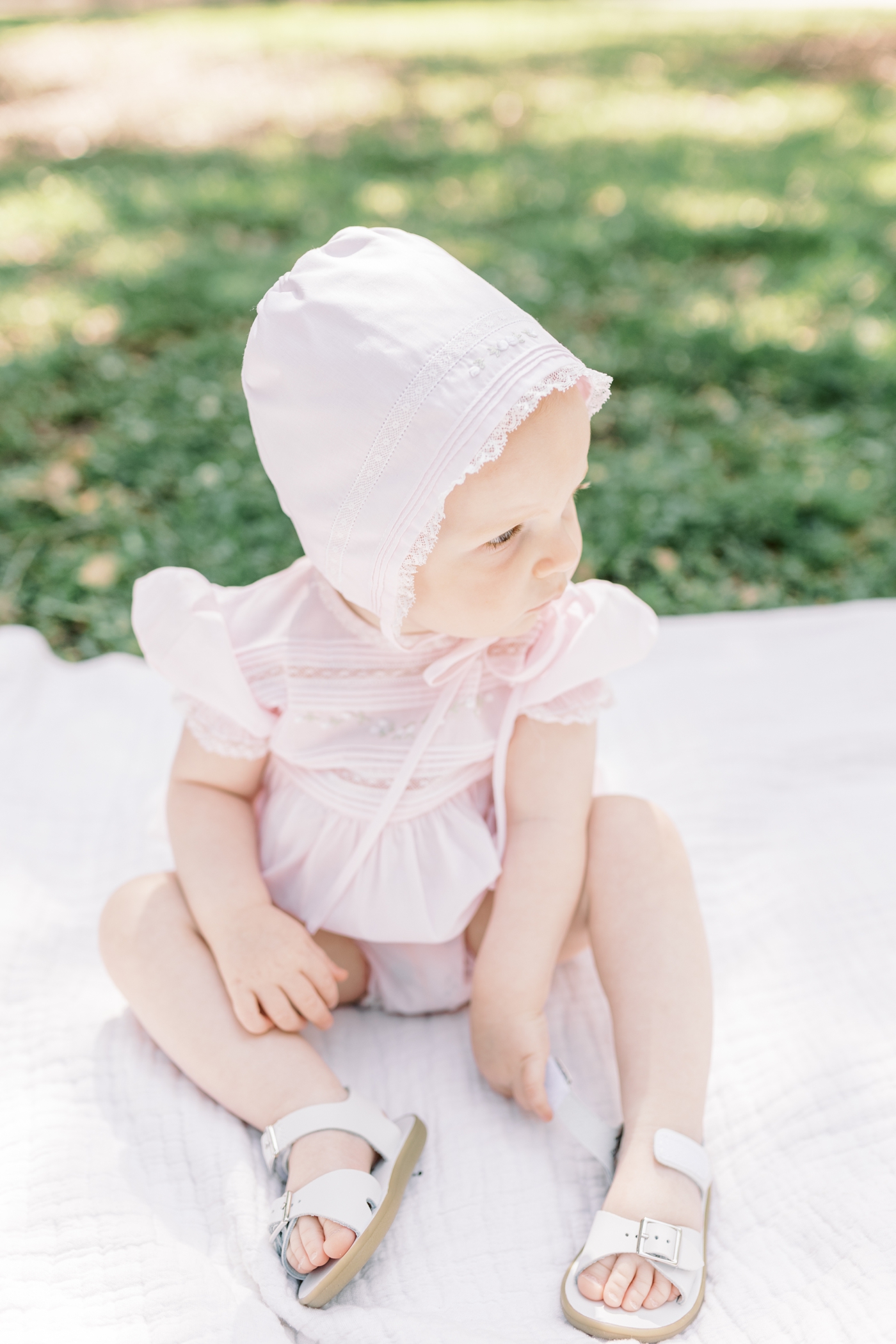 Baby girl in pink bonnet | Photo by Caitlyn Motycka Photography.