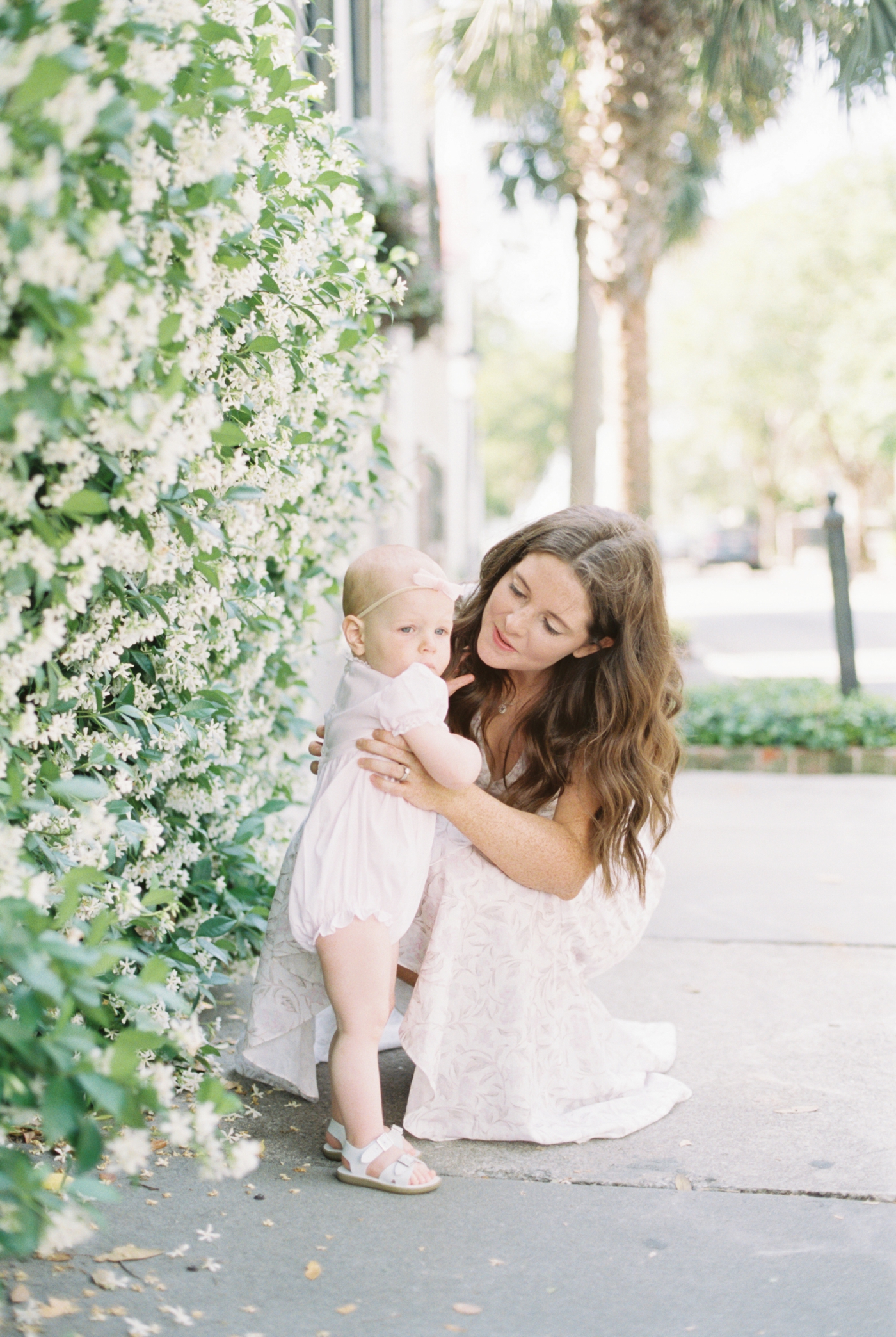 Mom chatting with baby daughter during 18month photo session downtown charleston | Photo by Caitlyn Motycka Photography.