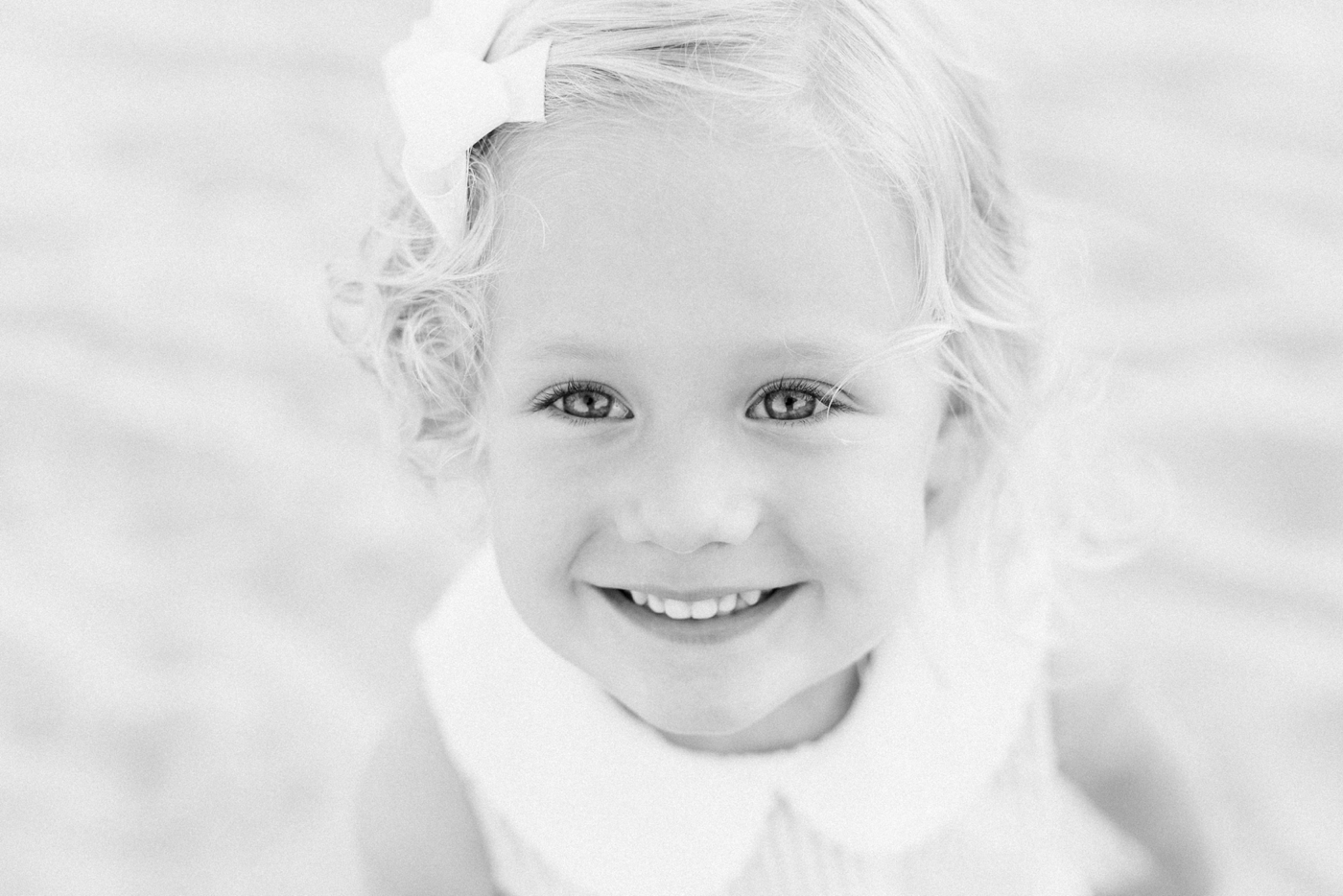 Black and white photo of little girl on the beach | Photo by Caitlyn Motycka Photography.
