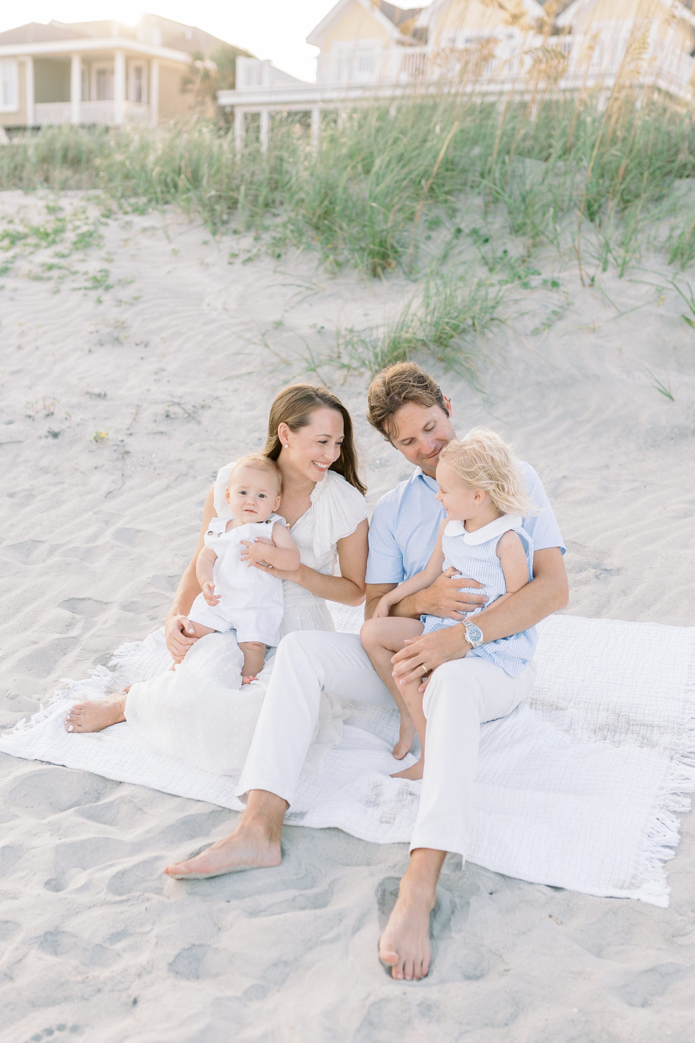 Family sitting on the beach during their Isle of Palms Family Session | Photo by Caitlyn Motycka Photography.