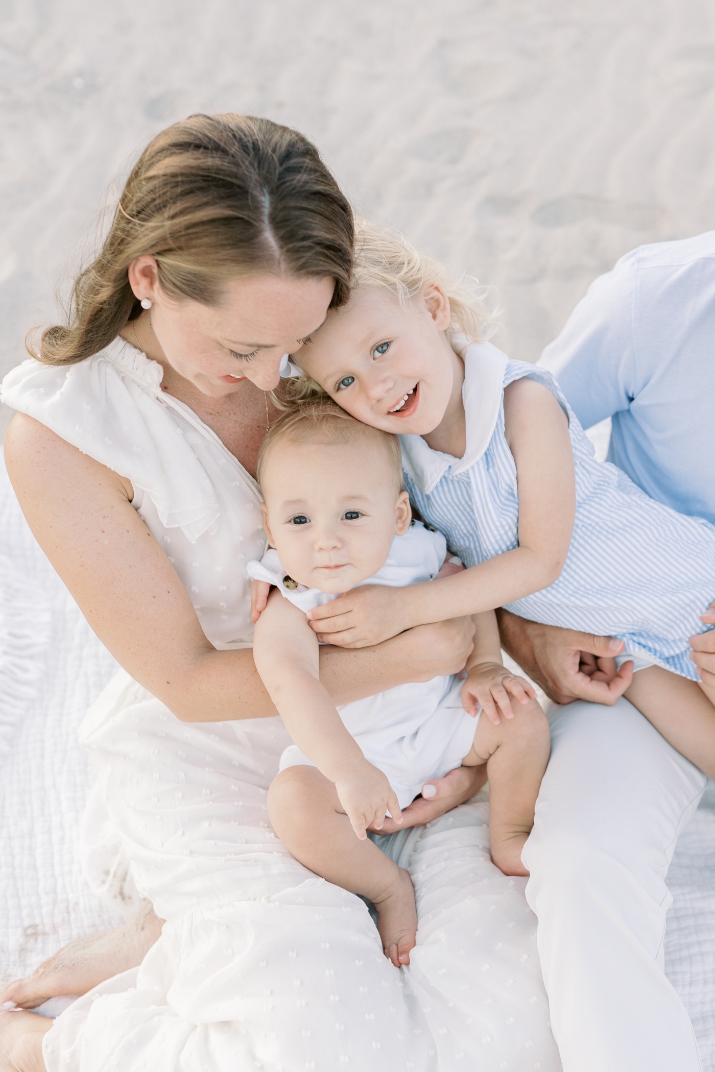 Mom snuggling with her little ones during their Isle of Palms Family Session |Photo by Caitlyn Motycka Photography.