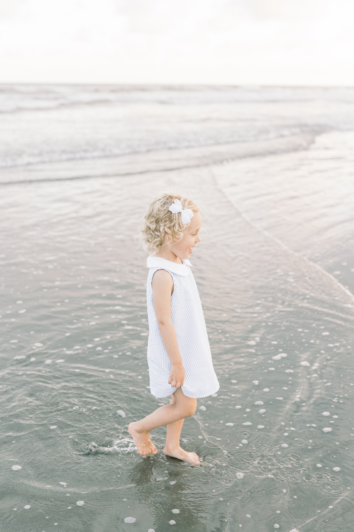 Little girl playing in the ocean | Photo by Caitlyn Motycka Photography.