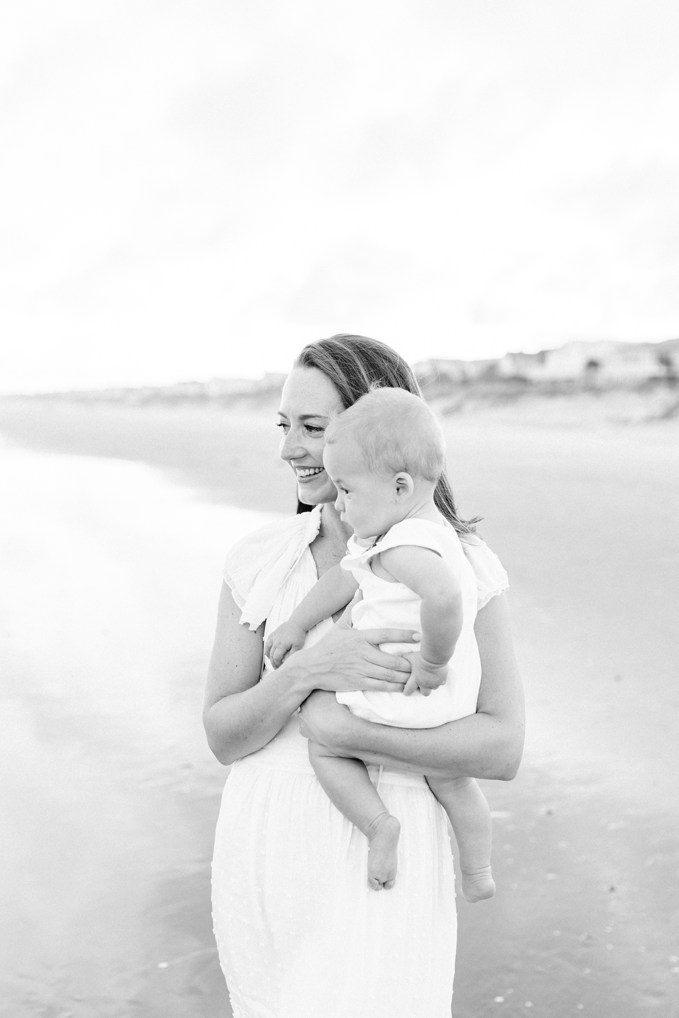 Black and white photo of mom holding baby boy | Photo by Caitlyn Motycka Photography.