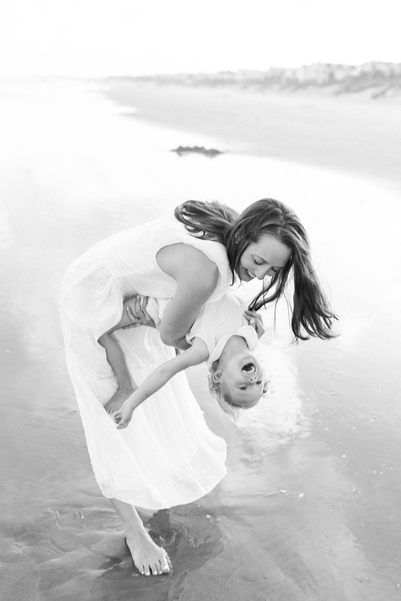 Mom playing with her daughter on the beach | Photo by Caitlyn Motycka Photography.